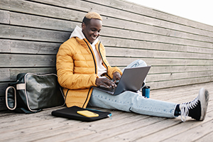 Man smiling using laptop