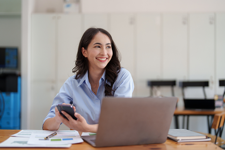 Woman smiling using laptop