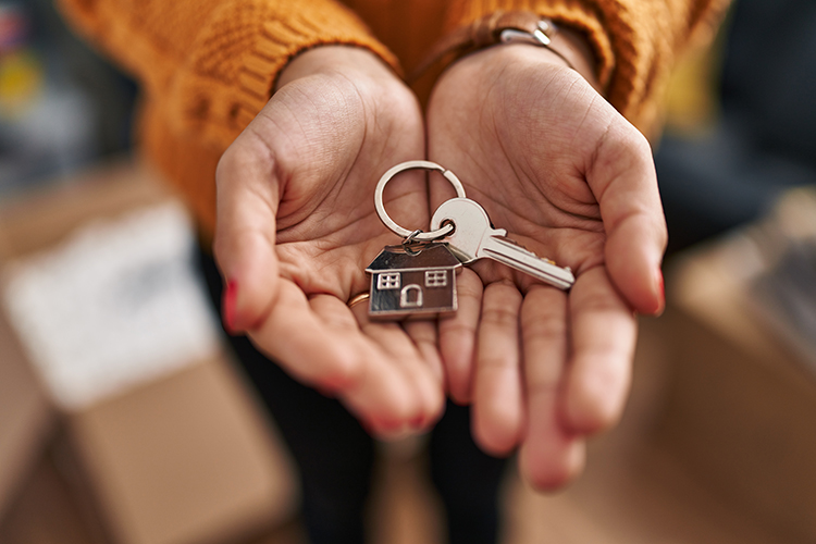 Hands holding house keys